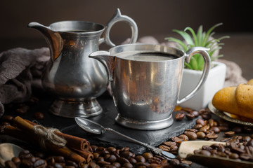 Coffee in a cup and saucer on an old background.