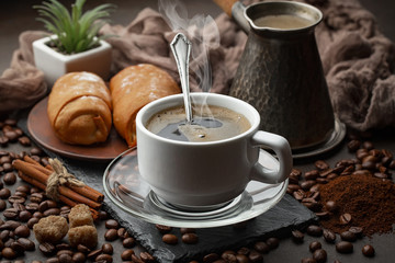 Coffee in a cup and saucer on an old background.
