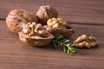 dried fruits, open nuts on wood