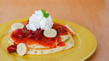 Buttermilk pancake filled with sliced banana and strawberries