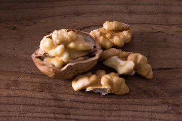 dried fruits, open nuts on wood