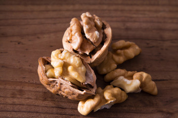 dried fruits, open nuts on wood