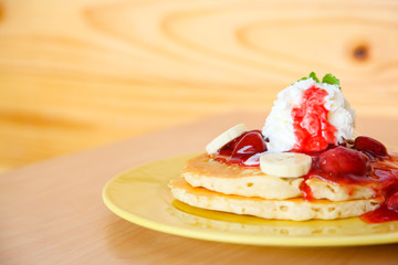 Buttermilk pancake filled with sliced banana and strawberries