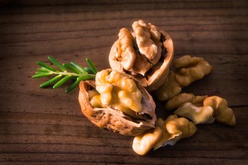 dried fruits, open nuts on wood
