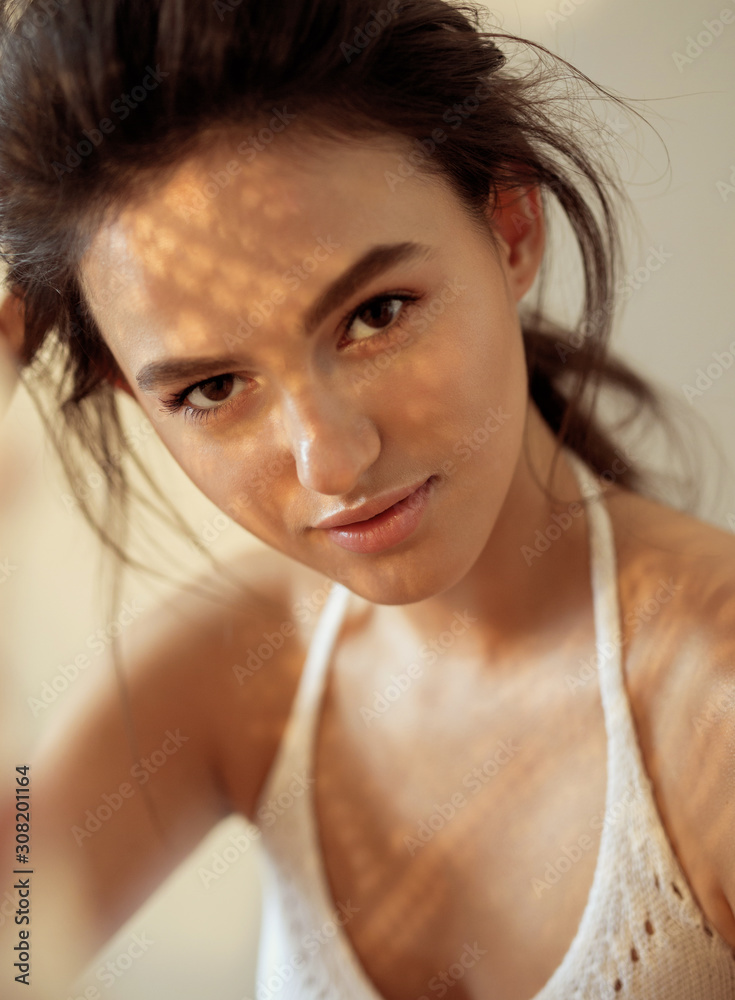 Wall mural portrait of a model on a sunny day shadows fall on the face and create a beautiful picture