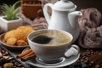 Coffee in a cup and saucer on an old background.
