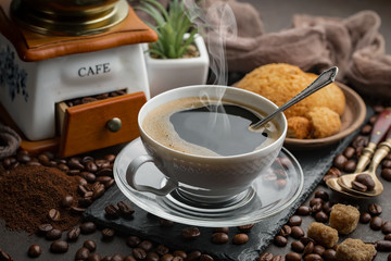 Coffee in a cup and saucer on an old background.