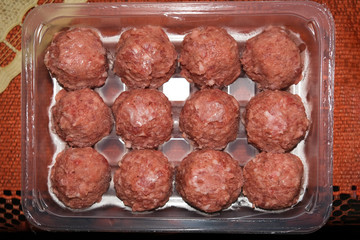 Frozen meatballs on a transparent substrate.