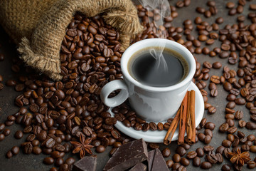 Coffee in a cup and saucer on an old background.