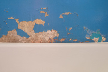 Old ragged wall. Blue Paint lags the surface.