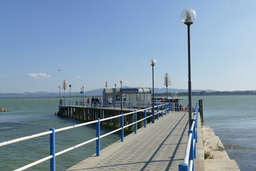 Naklejka premium pier for ferries to Maggiore Island and Polvese Island in the lakeside of Castiglione del Lago on Trasimeno Lake.