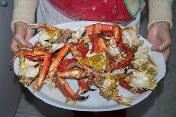 Seafood, woman holding chopped crab on tray