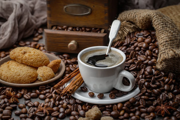 Coffee beans are roasted in a pan with smoke.