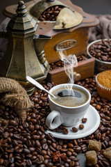 Coffee in a cup and saucer on an old background.