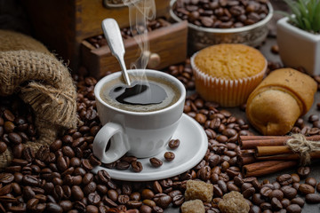 Coffee in a cup and saucer on an old background.