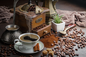Coffee in a cup and saucer on an old background.