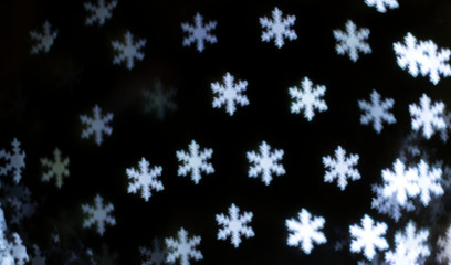 Bright snowflakes bokeh background. Happy new year
