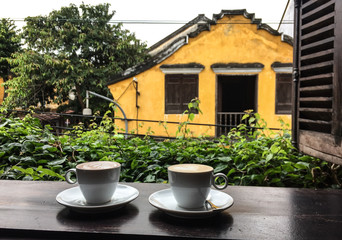 Cup of coffee on the wooden window
