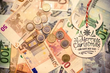 Happy New year and merry Christmas on the background of the Euro currency