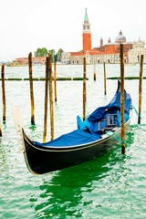 Gondola on traditional pier with wooden pillars