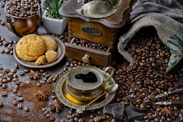 Coffee in a cup and saucer on an old background.