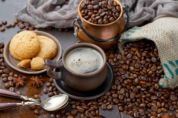 Coffee in a cup and saucer on an old background.