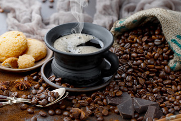 Coffee beans are roasted in a pan with smoke.