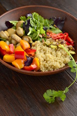 Salad with quinoa, sweet pepper, mushrooms, herbs and pistachios. Healthy nutrition. Vegetarian concept, vertical 