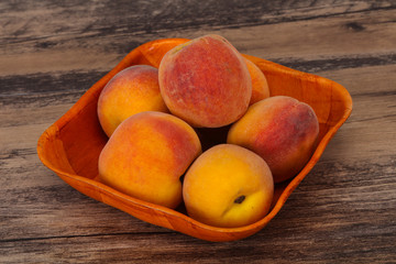 Peach heap in the wooden basket