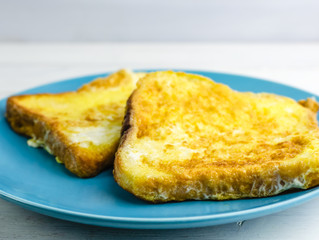 toast in an egg on a blue plate. Breakfast