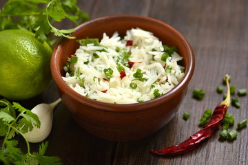 Basmati rice with lime, cilantro and garlic in ceramic bowls