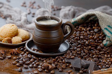 Coffee in a cup and saucer on an old background.