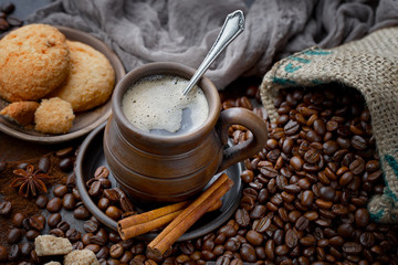 Coffee in a cup and saucer on an old background.