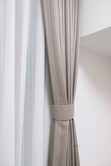 White and brown curtains with ring-top rail, Curtain interior decoration in living room.