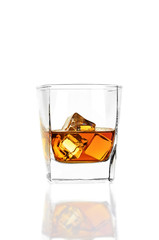 Whiskey with ice in a square glass isolated on a white background.