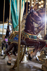 Horses on a merry-go-round with lights on a Christmas night