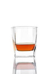 Whiskey in a square glass isolated on a white background.