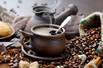 Coffee in a cup and saucer on an old background.