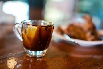  chocolate glass is on the brown wooden table