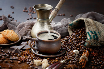 Coffee in a cup and saucer on an old background.