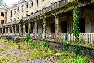 The ruins of the old Soviet sanatorium, whose architecture which is basically a synthesis of Stalinist period classical style and of Georgian ethnic decor with Gothic and Roman features - obrazy, fototapety, plakaty