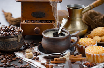 Coffee beans are roasted in a pan with smoke.