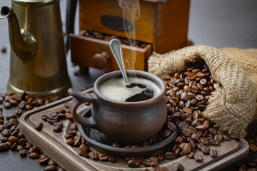 Coffee in a cup and saucer on an old background.