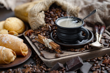 Coffee in a cup and saucer on an old background.