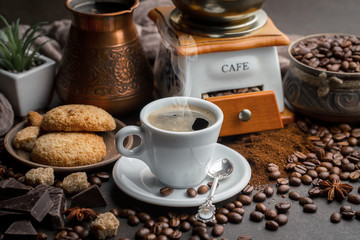Coffee in a cup and saucer on an old background.