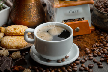 Coffee in a cup and saucer on an old background.