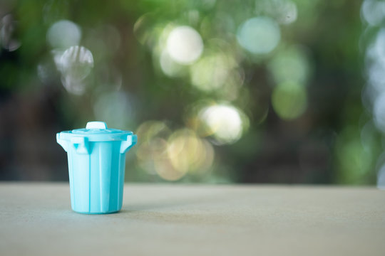 Miniature blue plastic garbage bin