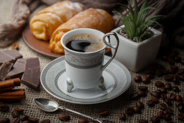 Coffee in a cup and saucer on an old background.