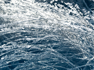 winter background with snowflakes crystals patterns and snow on frozen grass