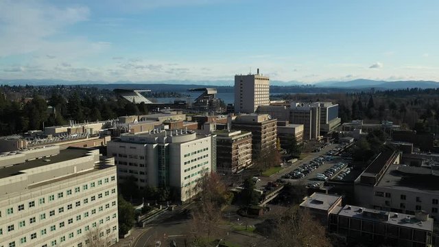 Drone footage of the University of Washington with the surrounding commercial and residential area, Husky Stadium, dormitories Hospital and classroom buildings in the background